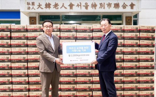 ▲8일 신왕섭 HDC현대산업개발 ESG소통실장(왼쪽)이 고광선 대한노인회 서울시연합회장에게 쌀 2톤을 전달하고 있다.